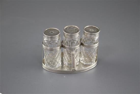 A George III silver oval ink bottle stand, London, 1799 (no makers mark), with three later Victorian silver monted glass bottles